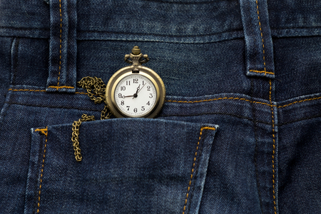 gold pocket watch in back pocket blue jean pants, this image for fashion and vintageの写真素材