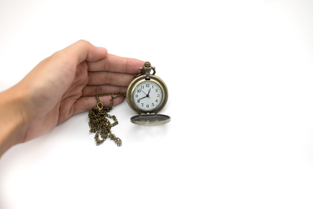women of hand holding rather old silver pocket watch on white background, this image for people and retro conceptの写真素材
