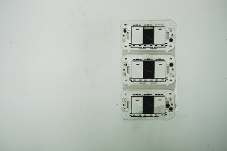 three plastic bare switch stick on white wall in room. this image for elertic, analog, interior, building, sefety conceptの写真素材