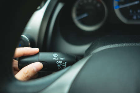 car interior background with young woman hand hold black handle. image for vehicle, body, object, switch conceptの写真素材