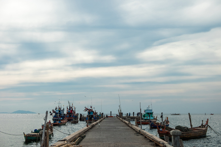 business background wooden bridge with fishing boat and sky, sea view. image for nature, southern, transportation, scenery, countryside, tropical conceptの写真素材