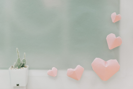 valentine day background pink paper heart and cactus plant with glass window. image for idea, love, celebration, nobody, copy space, decoration conceptの写真素材