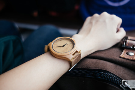 classic accessory background hand of business women wearing wooden watch with copy space. image for body, retro, outdoor, vintage, luxury, person, time, equipment conceptの写真素材