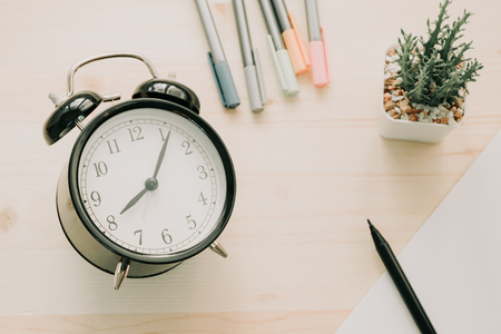 top view. plant, pen, calendar and clock placed on wooden background with copy space. image for business, time, object, isolated, retro, decoration, plant, nature, garden, workplace conceptの写真素材