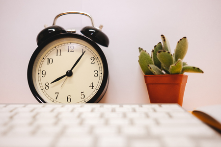 front view business table background with keyboard, clock and plant place on table. image for copy...