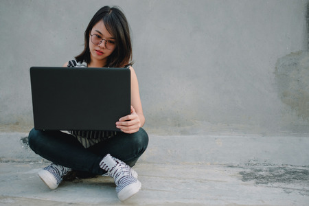 business people background business woman in glasses holding notebook and sitting on workplace. image for copy space, professional, technology, portrait, person, computer, worker, workspace conceptの写真素材