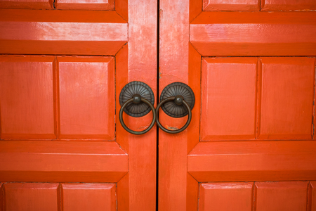 architecture background closeup wooden red door of ancient temple. image for antique, vintage, building, historical, religion conceptの写真素材