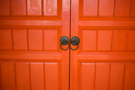 architecture background closeup wooden red door of ancient temple. image for antique, vintage,...