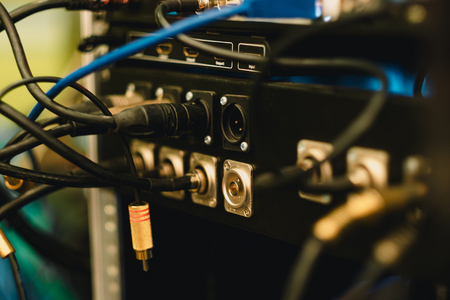 back panel electronic of music equipment with wire in studio background
