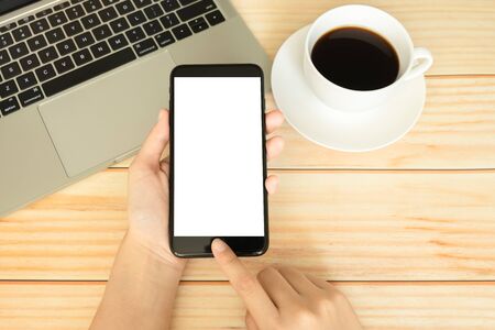 hand of women using smartphone and working in home office with coffee の写真素材