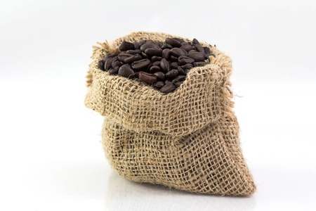 Coffee beans in a sack isolated on white backgroundの写真素材