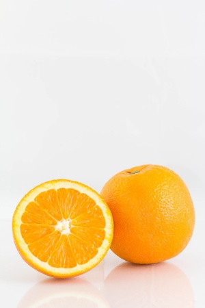 orange with half isolated on white backgroundの写真素材