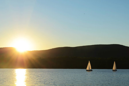 two boats on a lake during sunset timeの写真素材