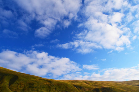 view on mountain range under thhe bright cloudy blue sky in Ukrainian Carpathiansの写真素材