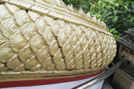 Naga gold statue in thai temple.の写真素材