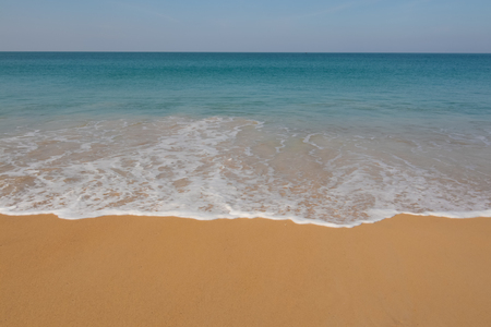 wave splashing on the sand beachの写真素材