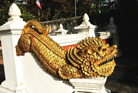 gold lion statue in a temple of Thailandの写真素材