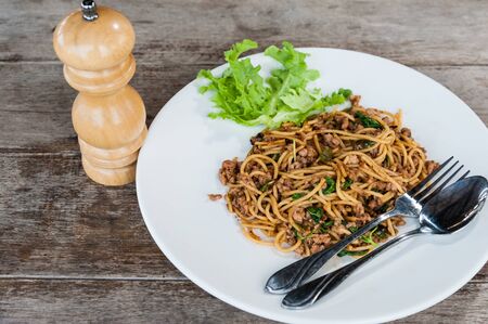 Spaghetti with tomato sauce and basil on forkの写真素材