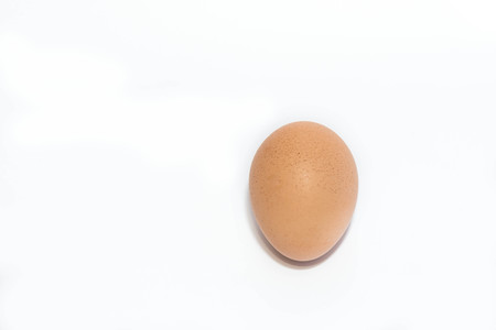 Single brown chicken egg isolated on white background