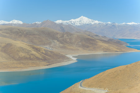 Yamdrok-tso lake shines on sunny blue sky day in Tibetの写真素材