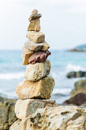 Pyramid of stones on the seashore. Selective focus.の写真素材
