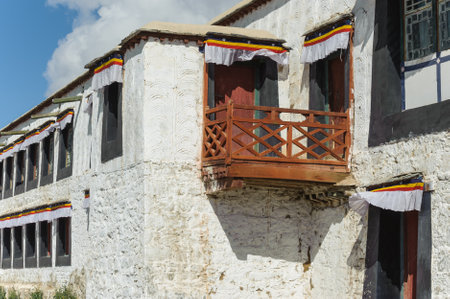 Buddhist prayer flags on the wall of a Buddhist monastery in Tibetの写真素材