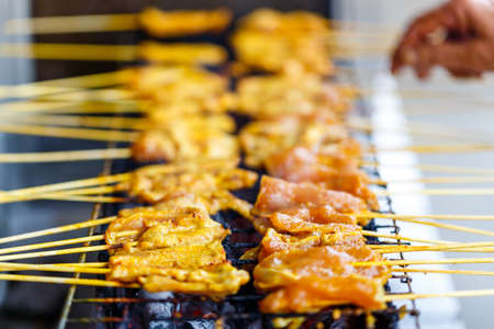 skewer barbecue yellow curry sauce grill with curry, pork grilled thai style Moo Satay