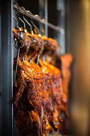 Roasted duck hanging on hooks Chinese restaurantの写真素材