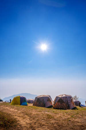 oil lantern hanging on Camping and tent under the pine forest at sunsetの写真素材