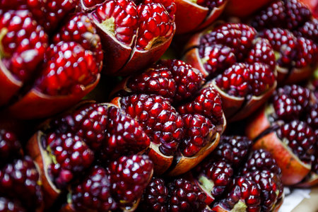 close-up sliced open red pomegranate backgroundの写真素材