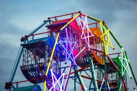 Colorful ferris wheel in amusement park, closeup of photo