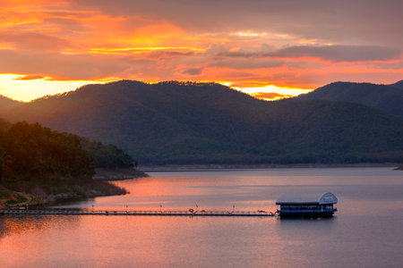 Mountains lake landscape in rainy season with sunset sky and cloudsの写真素材