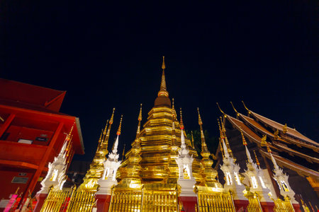 Sanctuary with golden pagoda Wat Phan Tao temple at night
