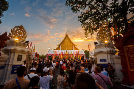 Chiang Mai City Pillar Inthakin Festival at evening twilight, crowd buddhist people make merit with flowers in Wat Chedi Luangの写真素材