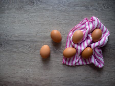 Eggs scatter on wooden tableの写真素材