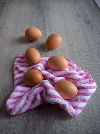 Eggs scatter on wooden tableの写真素材