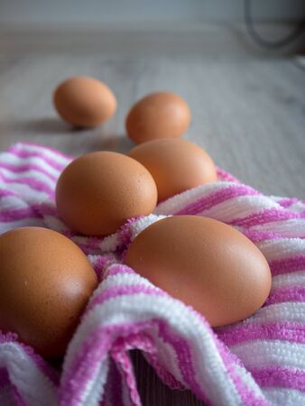 Eggs scatter on wooden tableの写真素材