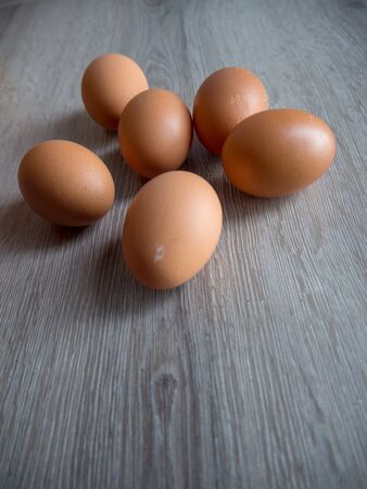 Eggs scatter on wooden tableの写真素材