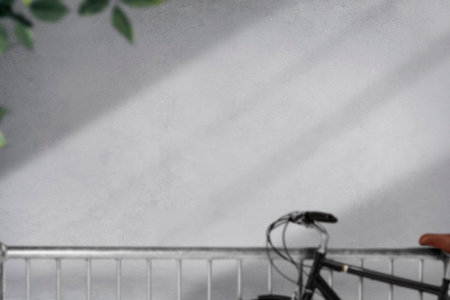 blurred image of bicycle leaning on wall with shadow from sunlight.の写真素材