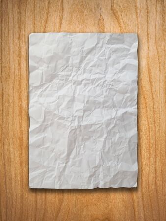 Crumpled paper on wood wallの写真素材