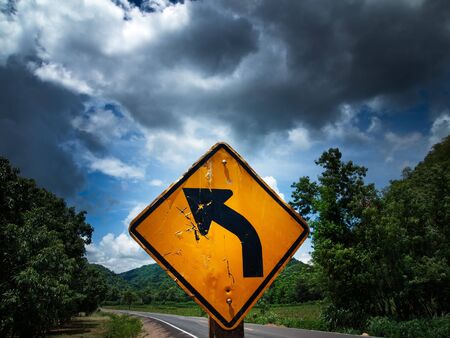 Road sign in left curve