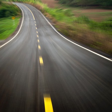 The road curves motion down form the mountainの写真素材