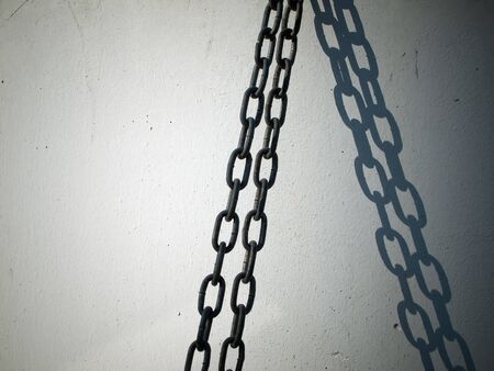 Chain linear shadow on the white wall