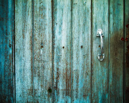 Old Door handle with an old wood door painted with green colorの写真素材