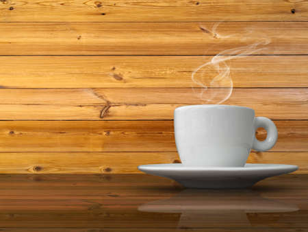 A white cup of coffee on wood table and wood wall backgroundの写真素材