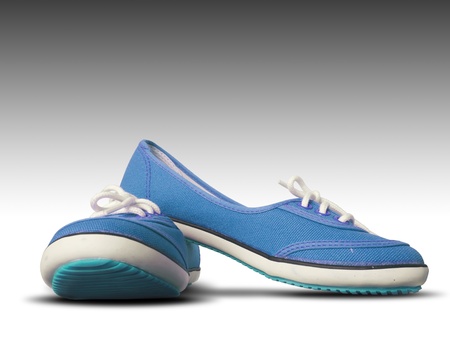 Blue fabric shoes on white background with shadowの写真素材