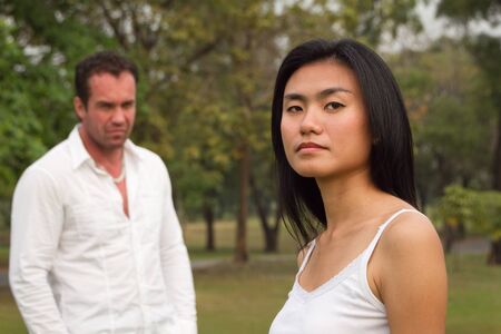 Women in front Man behind the angry partiesの写真素材