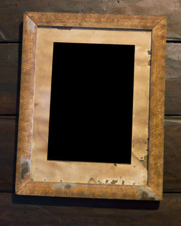 Old wooden picture frame hanging on the wall of woodの写真素材