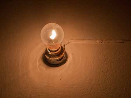 Traditional light bulb on wallの写真素材