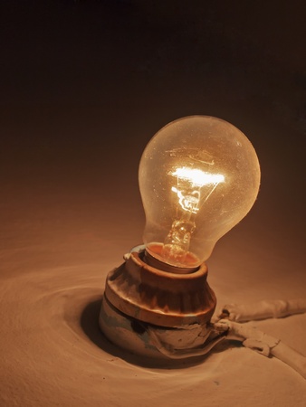 Traditional light bulb on wallの写真素材